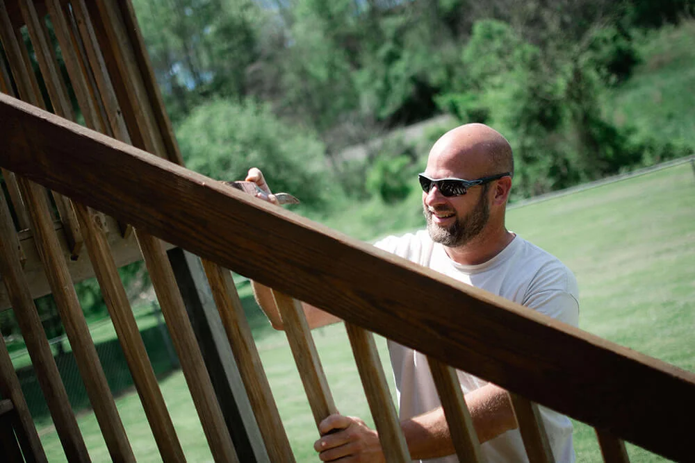 Honey Do Master Craftsman staining a deck