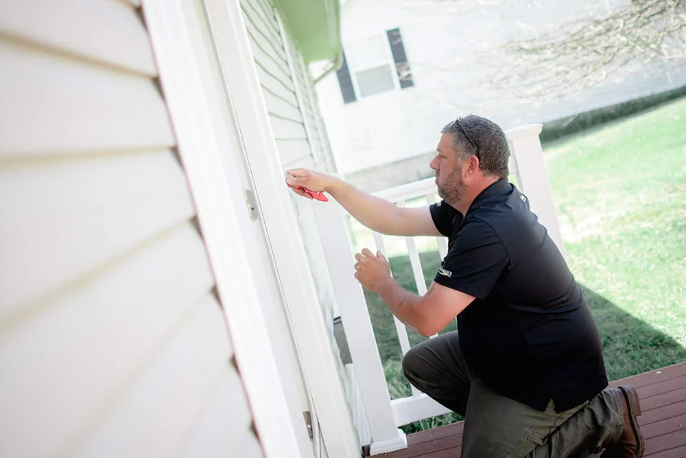 Honey Do Master Craftsman putting the finishing touches on a door frame repair