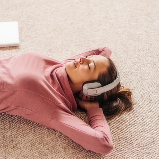 A young lady relaxing on a carpeted floor