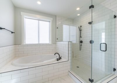 Professional shower and tub installation with glass enclosure and built-in tub