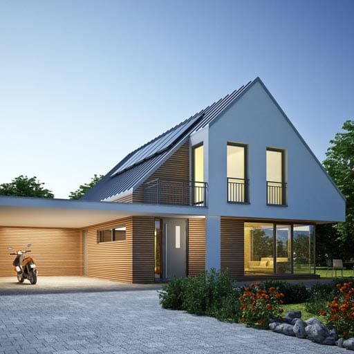 A modern home with a paved driveway that has been recently pressure washed