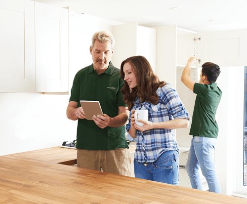 Honey Do worker discussing project with home owners